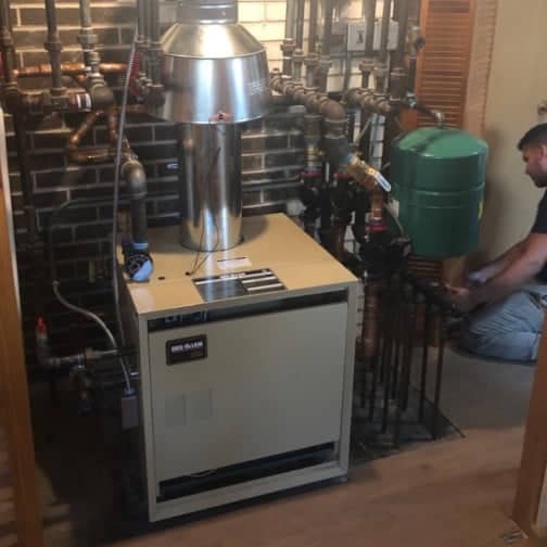 A Lindemann technician installing a boiler