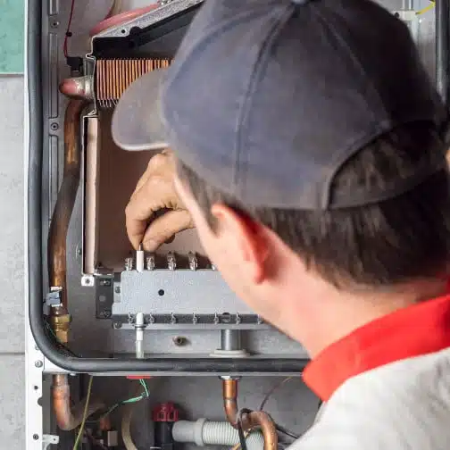 A Lindemann technician replacing a customers furnace with a new one